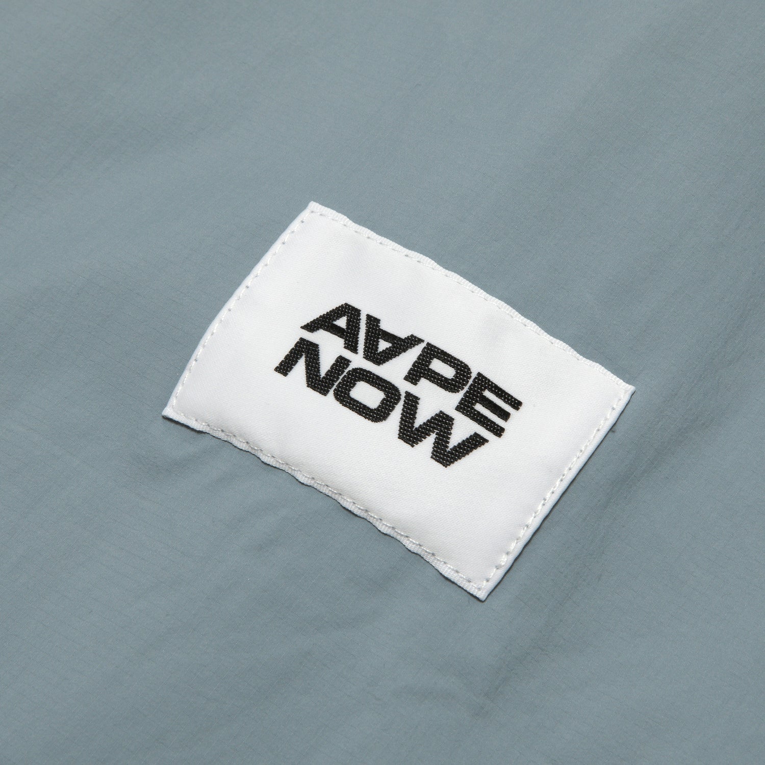AAPLJM7704XXO/AAPENOW MOONFACE LOGO WINDBREAKER JACKET