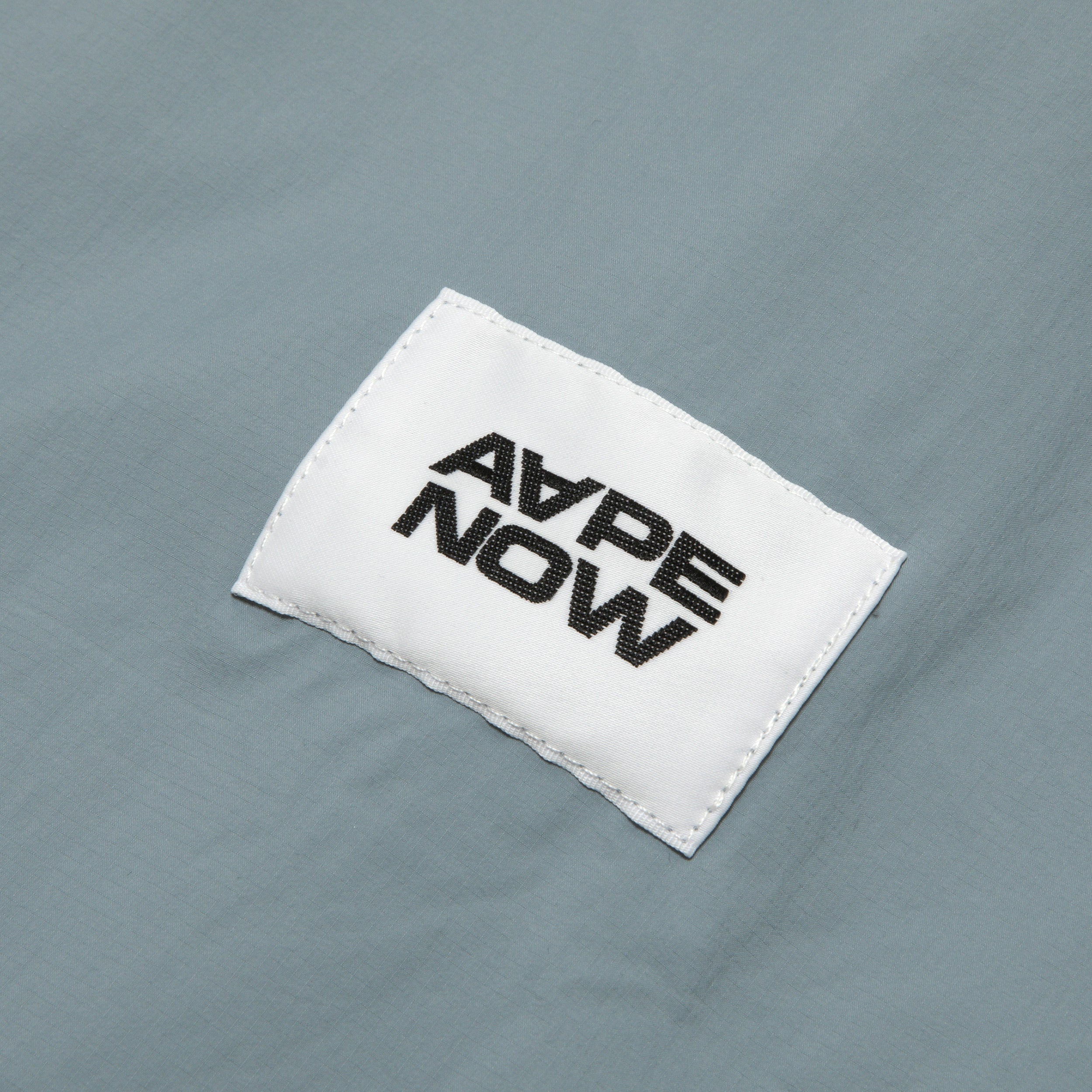AAPLJM7704XXO/AAPENOW MOONFACE LOGO WINDBREAKER JACKET