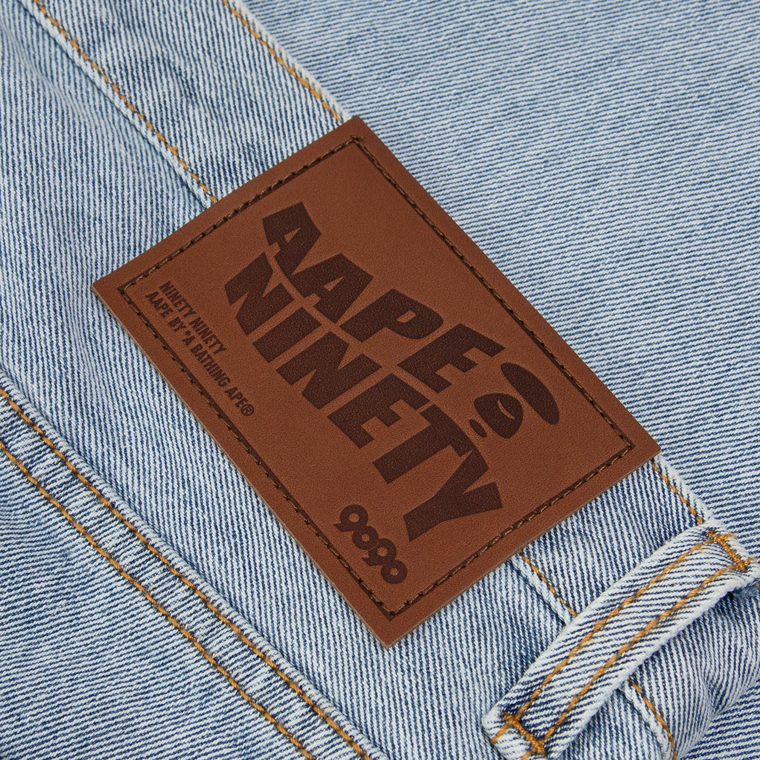 AAPE X 9090 STYLE MOONFACE PATCH DISTRESSED JEANS